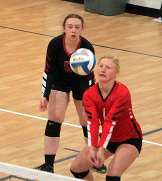 Kristin Wemhoff makes a pass against Filer as Riley Enneking watches.