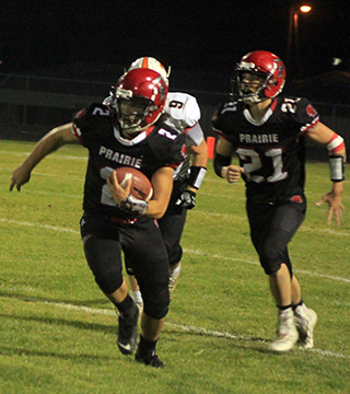 Eli Hinds carries the ball for several of his 132 yards rushing. Following is quarterback Colton McElroy.