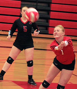 Kristin Wemhoff passes the ball in the Potlatch match. Also shown is Riley Enneking.