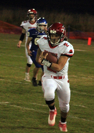 Eli Hinds gains some of his 167 yards rushing against Genesee. In the background is quarterback Colton McElroy.