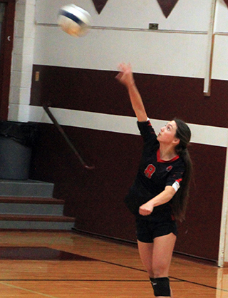 Julia Rehder serves in Prairie's final regular season league game at Kamiah.
