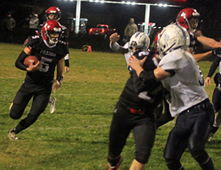 Trenton Lorentz runs the ball as Eli Hinds and Quirt Goeckner block for him. Behind him is Colton McElroy.