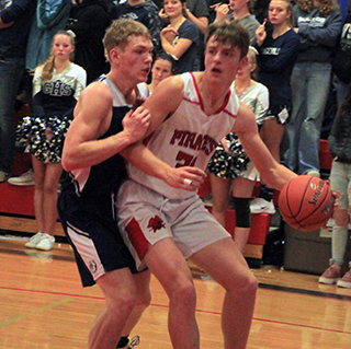 Lee Forsmann works against a Grangeville defender along the baseline.