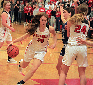 Tara Schlader drives the side of the lane as Alli Geis sets a pick against a Grangeville defender. Also shown is Kristin Wemhoff.