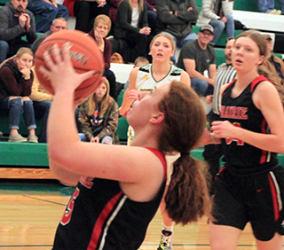 Riley Enneking is about to score against Potlatch. Also shown is Kylie Schumacher.