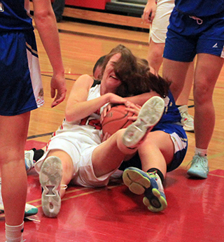 Tara Schlader and a Genesee player battle for the ball. Of course a jump ball was called.