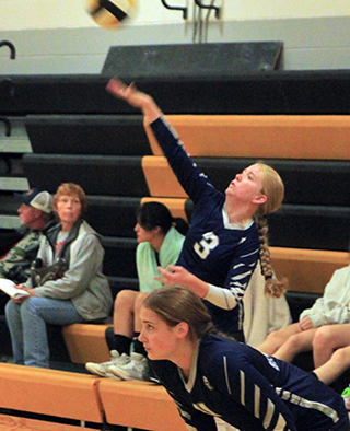 Rachel Sonnen serves at the Timberline Tournament. Also shown is Sarah Waters.