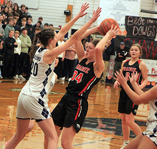 Kylie Schumacher is defended in the post by Grangeville. Also shown is Lexi Schumacher.