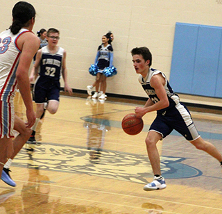 Cody Weckman handles the ball against Lapwai. Also shown is Zachary Murdock.