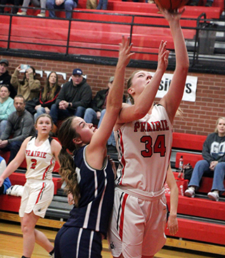 Kylie Schumacher scores a lay-up in the District opener against Logos. Also shown is Lexi Schumacher.