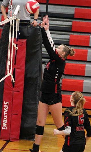 Beka Schumacher pushes the ball over at C.V. Also shown is Kylee Riggers.