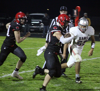 Chris Schumacher breaks through the line. He went 72 yards on this play for a touchdown. Also shown is Max Rehder.