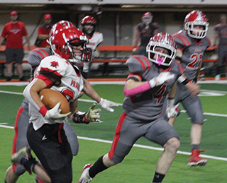 Isaiah Warren returns a kickoff against Grace.