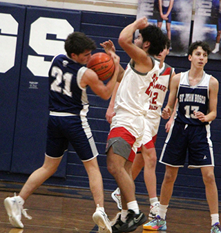 Cody Weckman steals the ball against C.V. at Grangeville. Also shown is Joseph Waters.
