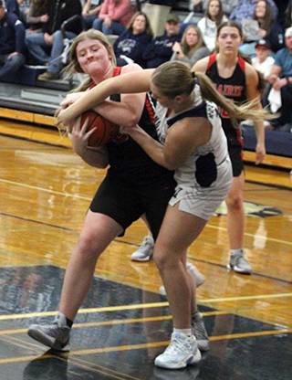 Hailey Hanson battles with a Grangeville player for the ball. Also shown is Reagan Brannan.